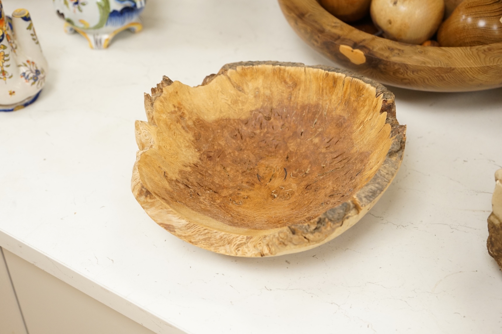 A modern treen yew bowl, a burr wood bowl and various fruit
